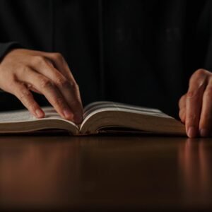 a person is reading a book on a table
